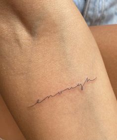 a woman's arm with the word love written in cursive writing on it