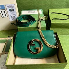 Coming from the House's archives, a round shaped version of the Interlocking G logo is reintroduced for Gucci Love Parade. Crafted from emerald green leather, this shoulder bag is completed by a delicate chain strap, infusing this accessory with a refined feel. Gold-toned hardware Round Interlocking G Leather shoulder strap with 15.4" drop Magnetic closure Small: 11"W x 6.3"H x 1.6"D Made in Italy Gucci Blondie Bag, Gucci Green Bag, Bags Wishlist, Green Gucci, Tas Bahu, Gucci Brand, Green Leather, Chain Strap, Wallet Case