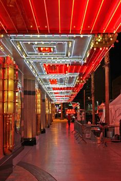 the walkway is lit up with red and white lights