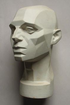 a white mannequin head is shown against a gray background