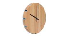 a clock made out of wood with blue tape around it