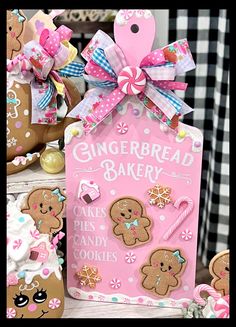 gingerbread bakery sign with cookies and candies on it next to some other decorations