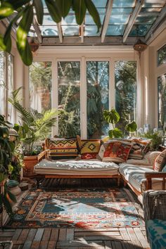 a sun room with lots of windows and plants