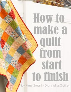 a quilt hanging on a clothes line with the words how to make a quilt from start to finish