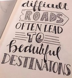 an open book with the words difficult roads often lead to beautiful destinations