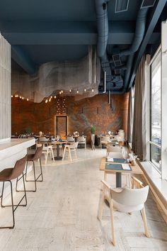 an empty restaurant with wooden tables and chairs