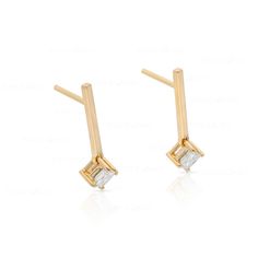 These sleek, modern bar earrings feature two princess-cut diamonds set in lustrous 10k gold. Perfect for the fashion-conscious, contemporary woman, they will be an eye-catching addition to any outfit. Modern Formal Earrings With Single Diamond, Modern Single Diamond Earrings For Formal Occasions, Modern Baguette Diamond Earrings As Gift, Modern 14k Gold Earrings With Baguette Diamonds, Modern Diamond Linear Earrings, Modern Gold Baguette Cut Diamond Earrings, Modern Gold Diamond Earrings With Baguette Cut, Modern Baguette-shaped Gold Earrings, Modern Gold Baguette Earrings