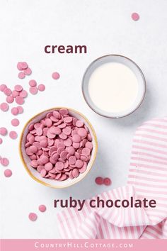 a bowl filled with pink marshmallows next to a cup of milk on top of a table