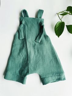 Dashes of Love knot romper Our popular knot romper now in double gauze fabric Comfortable effortless style Adjustable straps by tying the knot at different points. Cuffed hem Elastic in back 4 beautiful fabrics to choose from our crystal collection: ~ Jade (as pictured) ~Rose Quartz ~Onyx ~Amethyst Summer Green Jumpsuits And Rompers With Bib Front, Cotton Overalls With Tie Straps, Cute Bib Front Overalls For Summer, Green Bib Front Overalls For Summer, Cotton Summer Overalls For Beach, Summer Cotton Overalls For Beach, Casual Summer Overall Bubble Romper, Sleeveless Summer Overalls With Tie Straps, Summer Sleeveless Overalls With Tie Straps