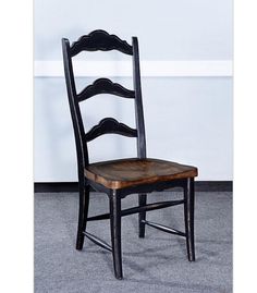 a wooden chair sitting on top of a carpeted floor next to a white wall