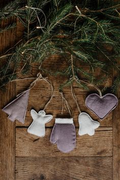 three felt angel ornaments hanging from a tree