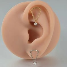 a fake ear with two piercings attached to it