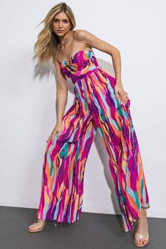 A printed woven jumpsuit featuring strapless twisted bodice with center cut out, pleated pant and smocked back bodice Details: Self : 100% Spring Vacation Strapless Jumpsuit With Smocked Bodice, Summer Strapless Jumpsuits And Rompers With Elastic Waistband, Strapless Jumpsuits And Rompers With Elastic Waistband For Vacation, Summer Bandeau Jumpsuits And Rompers With Elastic Waistband, Summer Bandeau Jumpsuit With Elastic Waistband, Bandeau Jumpsuits And Rompers With Elastic Waistband For Spring, Strapless Beach Jumpsuits With Smocked Bodice, Summer Strapless Jumpsuit With Elastic Waistband, Strapless Jumpsuits And Rompers With Elastic Waistband