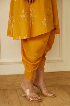 Ochre kurta with gold foil floral print and gota detail. Paired with tulip dhoti pant.
Components: 2
Pattern: Printed
Type Of Work: Floral,Foil
Neckline: Keyhole
Sleeve Type: Bell
Fabric: Cotton Silk, Handwoven Kota Doriya
Color: Yellow
Other Details: 
Gota detail
Kurta front drawstring
Occasion: Sangeet,Mehendi and Haldi - Aza Fashions Tulip Dhoti, Kurta With Dhoti, Dhoti Pants, Pant For Women, Foil Print, Pant Set, Cotton Silk, Aza Fashion, Fabric Cotton