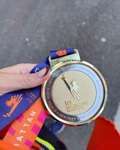 a person holding up a medal in their hand