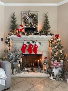 a fireplace decorated for christmas with stockings hanging from the mantel and candles on either side