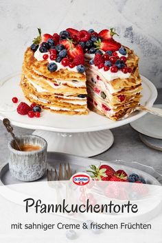 a cake with berries and cream on top