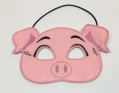 a pink pig mask with eyes and nose