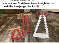 two christmas trees made out of cardboard are on the floor next to each other and tied with twine