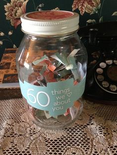 a glass jar filled with confetti on top of a table