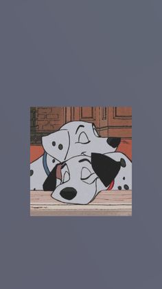 two dalmatian dogs laying down on the floor with their heads touching each other