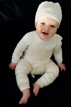 a baby wearing a white hat and diaper