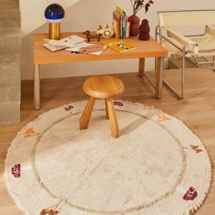 a living room with a white rug and wooden table