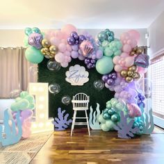 an under the sea themed party with balloons, mermaid tailes, and other decorations