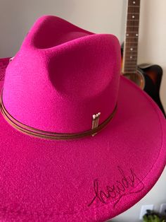 Make a statement with the Howdy hat! This hot pink, dolly parton inspired style is the perfect way to introduce some western flair into your wardrobe. The unique howdy detail will make sure you stand out in a crowd! The hot pink howdy hat is the perfect addition to your western wardrobe Western Pink Hat With Curved Brim, Pink Brimmed Hat For Rodeo, Western Style Pink Hat With Curved Brim, Pink Wide Brim Hat For Rodeo, Pink Flat Brim Hat For Country Events, Pink Felt Hat With Curved Brim For Kentucky Derby, Pink Curved Brim Felt Hat For Kentucky Derby, Pink Fedora Hat For Festival, Pink Brimmed Hats For Country Events