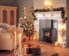 a living room filled with furniture and a fire place in front of a christmas tree