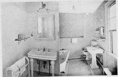 an old photo of a bathroom with two sinks