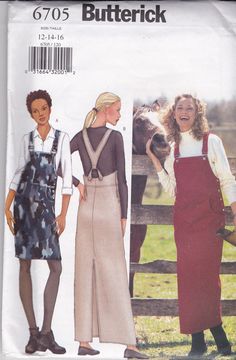 two women wearing aprons and overalls in front of a fence