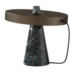 a table with a black and white marble design on it's top, connected to a brown cord