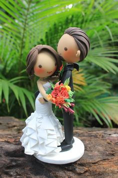 a wedding cake topper with a bride and groom