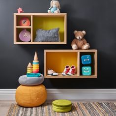 a child's playroom with toys and bookshelves on the wall,