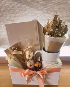 a gift box filled with chocolates, cookies and flowers