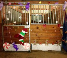 two gates decorated with christmas decorations and candy canes in front of a wooden wall