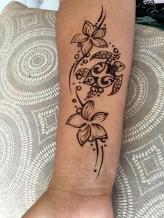 a woman's arm with a tattoo design on the left side of her leg