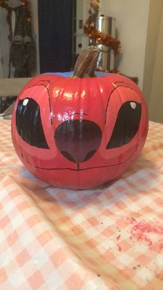 a painted pumpkin sitting on top of a table