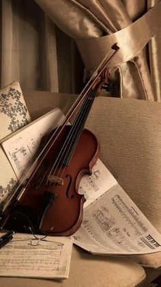 a violin and music sheets on a table