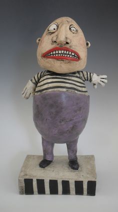 a ceramic sculpture of a man in jail clothes