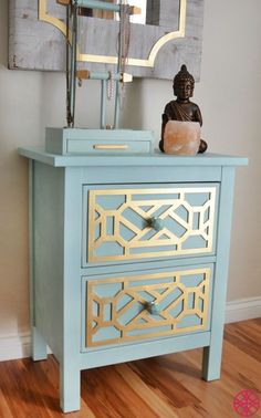 a blue and gold dresser with a buddha statue on top