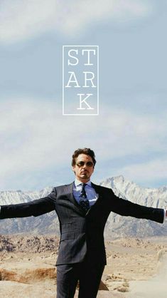 a man in a suit and tie with his arms spread out to say i am ironman