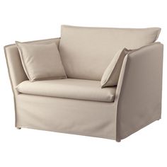 a beige chair with two pillows on the armrests and one pillow in front of it