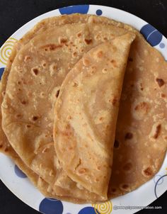 three tortillas on a blue and white plate