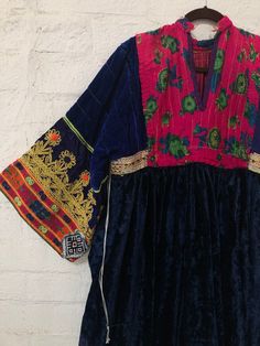 "A gorgeous, traditional Afghani Kutchi dress made by hand. Me asurements are 20\" across the chest. 48\" from mid shoulder to the bottom of the piece. 19 1/2\" long from shoulder to wrist." Bohemian Dress With Embroidered Neckline And Traditional Drape, Folk Style Embroidered Transitional Dresses, Folk Style Dress With Embroidered Border For Festivals, Bohemian Embroidered Dress With Traditional Drape For Ceremonial Occasions, Folk Dresses With Embroidered Border For Festivals, Bohemian Floral Embroidered Dress For Transitional Seasons, Traditional Tunic Dress With Floral Embroidery, Traditional Dress With Embroidered Neckline, Folk Style Embroidered Dress With Traditional Drape