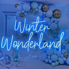 the words winter wonderland are lit up with balloons