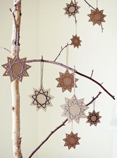 an ornament hanging from a tree branch in the shape of stars on it