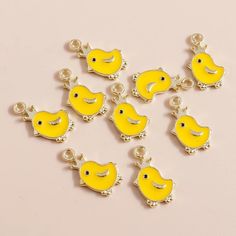 Mini yellow chick charms  Zinc alloy and enamel, gold metal reverse The charms  measure approximately 16mm x 10mm The chicks have little gold crowns  choose from a set of 2 or a set of 5 Not suitable for children under three years postage will only be applied to the first item in the basket Cute Gold Metal Charms, Cute Yellow Charms Jewelry, Cute Yellow Jewelry With Charms, Yellow Enamel Jewelry With Charms, Strawberry Clothing, Gold Crowns, Easter Jewelry, Mini Iron, Cute Patches