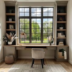 a home office with large windows and wooden shelves on the wall, along with a rug in front of it